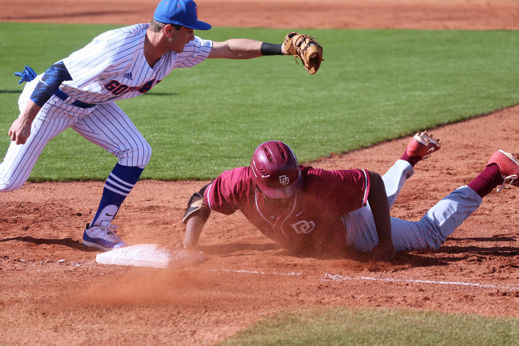 Desert Oasis' Jacob Walsh (21) slides back to first base safely against Bishop Gorman's John Ga ...