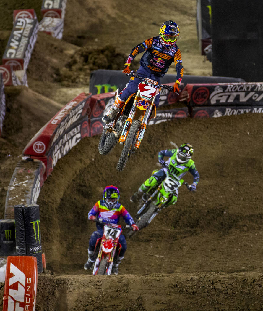 Red plate points leader Cooper Webb (2) takes a big jump as he leads the pack during the featur ...