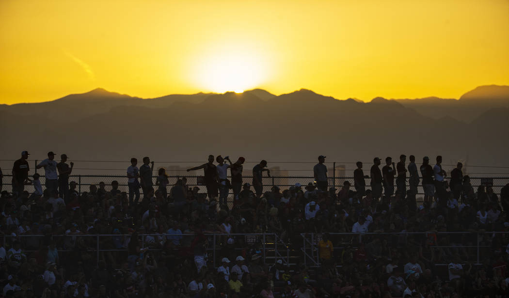 The sun sets behind fans during the featured 450 SX class race at Sam Boyd Stadium on Saturday, ...