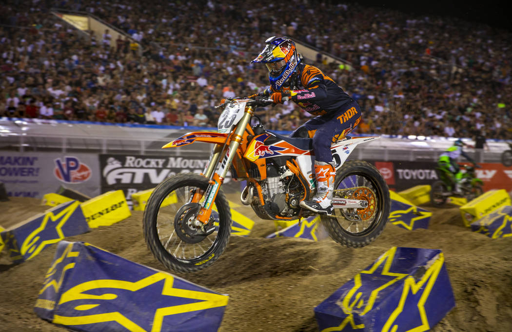 Red plate points leader Cooper Webb (2) maneuvers along the track during the featured 450 SX cl ...