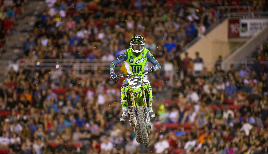 Eventual race winner Eli Tomac (3) soars above the track during the featured 450 SX class final ...