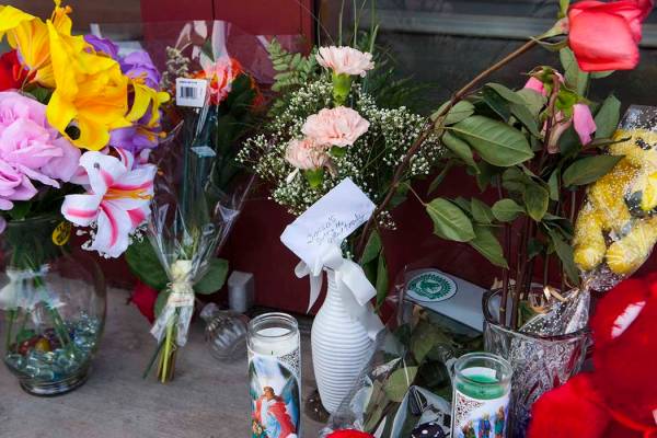 Flowers sit in front of Jared, a jewelry store where employee Kimberlee Ann Kincaid-Hill died a ...