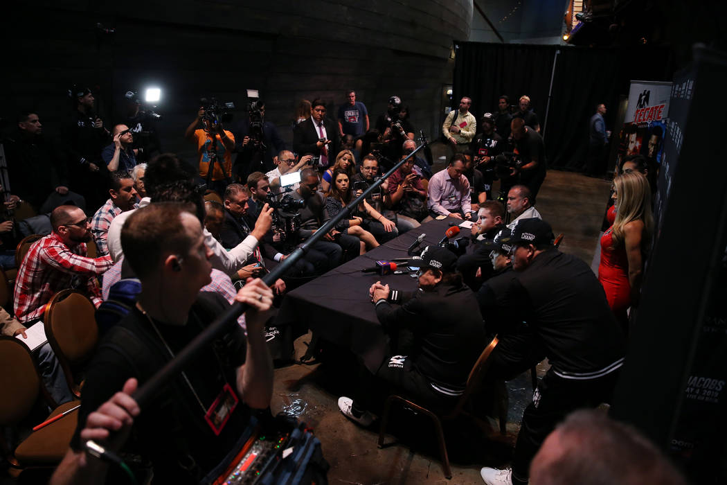 Saul "Canelo" Alvarez, right, speaks to reporters during a press conference at the MG ...