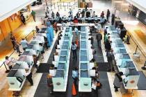 Voters cast their ballots as others sign in at a polling station at Galleria Mall on Tuesday, N ...