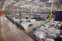 Detainees sleep and watch television in a holding cell where hundreds of mostly Central America ...