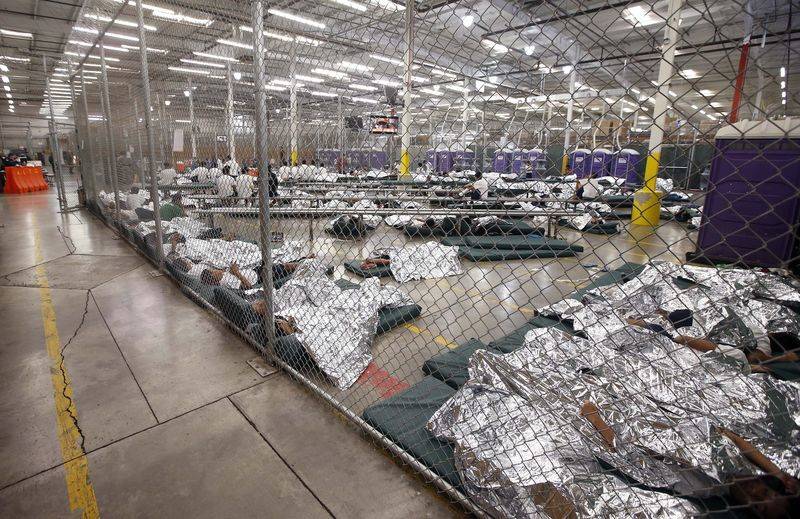 Detainees sleep and watch television in a holding cell where hundreds of mostly Central America ...