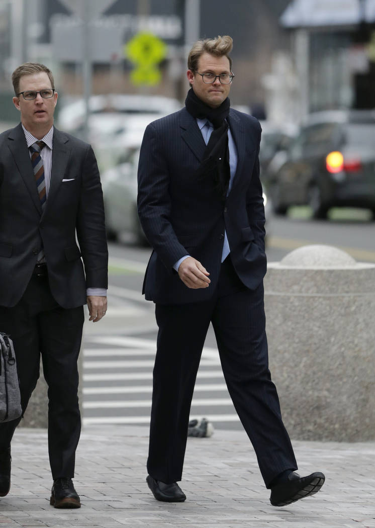 Mark Riddell, right, arrives at federal court Friday, April 12, 2019, in Boston, where he was s ...