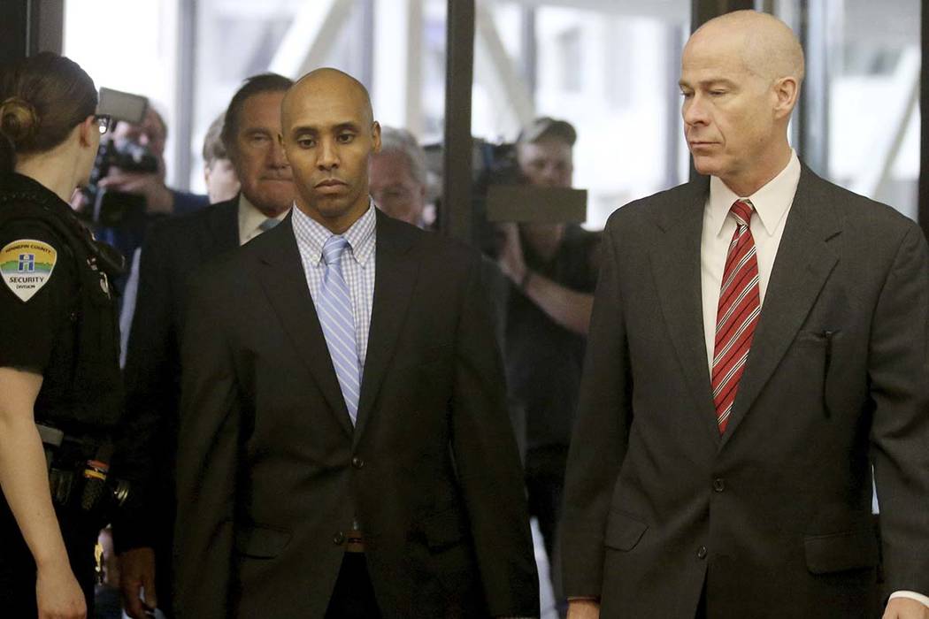 Former Minneapolis police officer Mohamed Noor walks through the skyway with his attorney Thoma ...