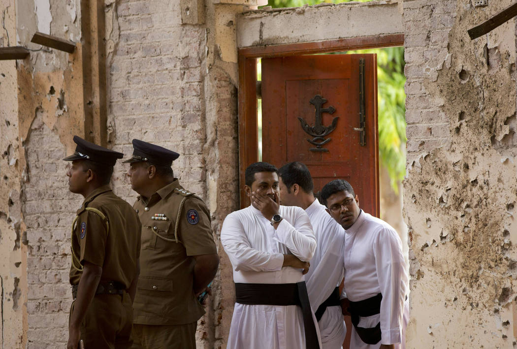 FILE - In this April 22, 2019, file photo, clergymen visit the scene of a suicide bombing at St ...