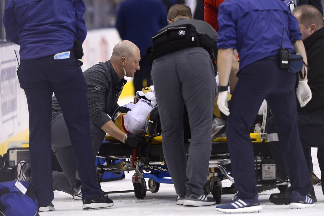 Vegas Golden Knights center Erik Haula (56) is taken off the ice on a stretcher after taking a ...