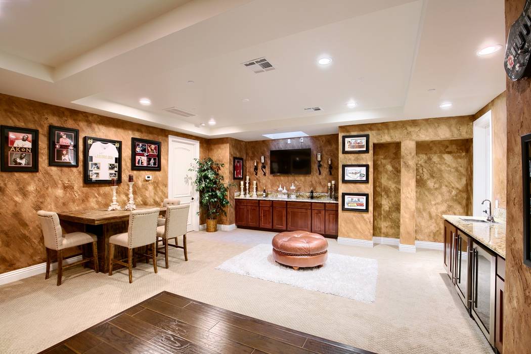 The basement has a game room, bar and theater. (Signature Real Estate Group)