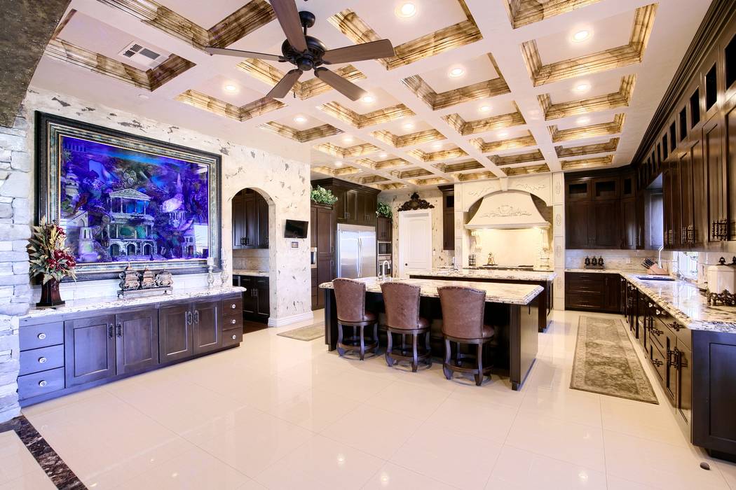 The kitchen features a custom 700-gallon aquarium with 25 sea creatures, including angelfish, t ...