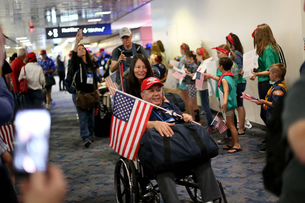 U.S. Air Force veteran Leo Mainwal, with guardian Brenda Mainwal, greets people as they welcome ...