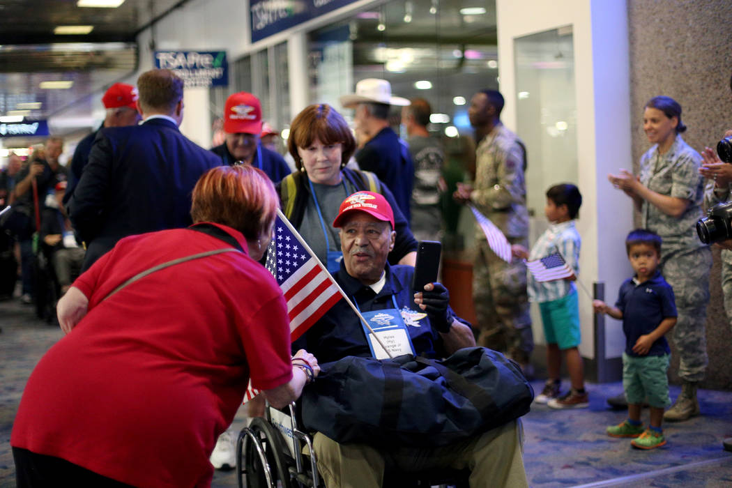 Veteran Hylas "Hy" Strange Jr. greets people as they welcome him back from a trip to ...