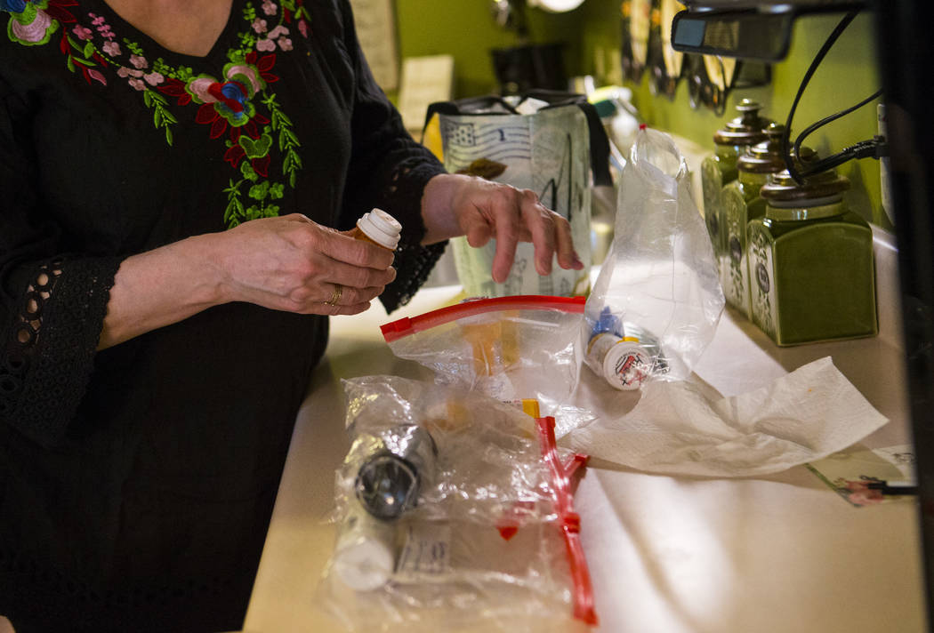 Kay McClure prepares medication for her son, Grayson McClure, at their home in Collierville, Te ...