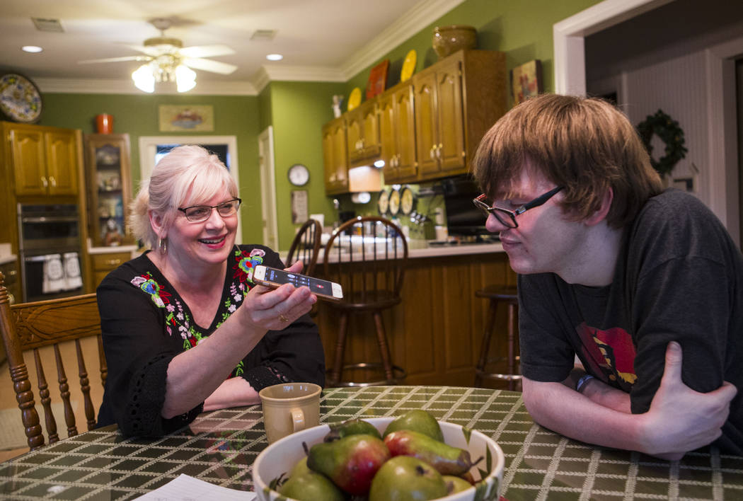 Kay McClure, left, and Grayson McClure talk on the phone with Dr. Bruce Fong, Grayson's Reno-ba ...