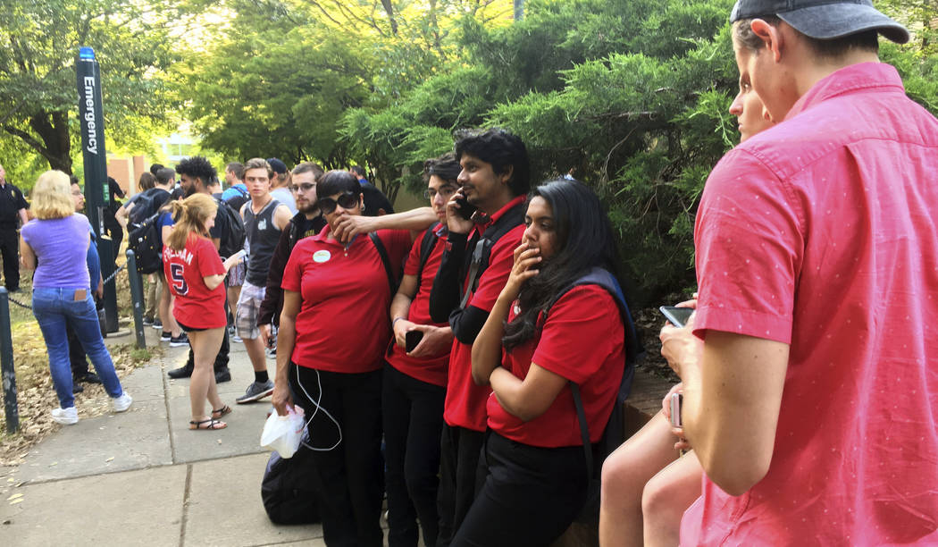 Students gather on the campus of the University of North Carolina Charlotte after a shooting Tu ...