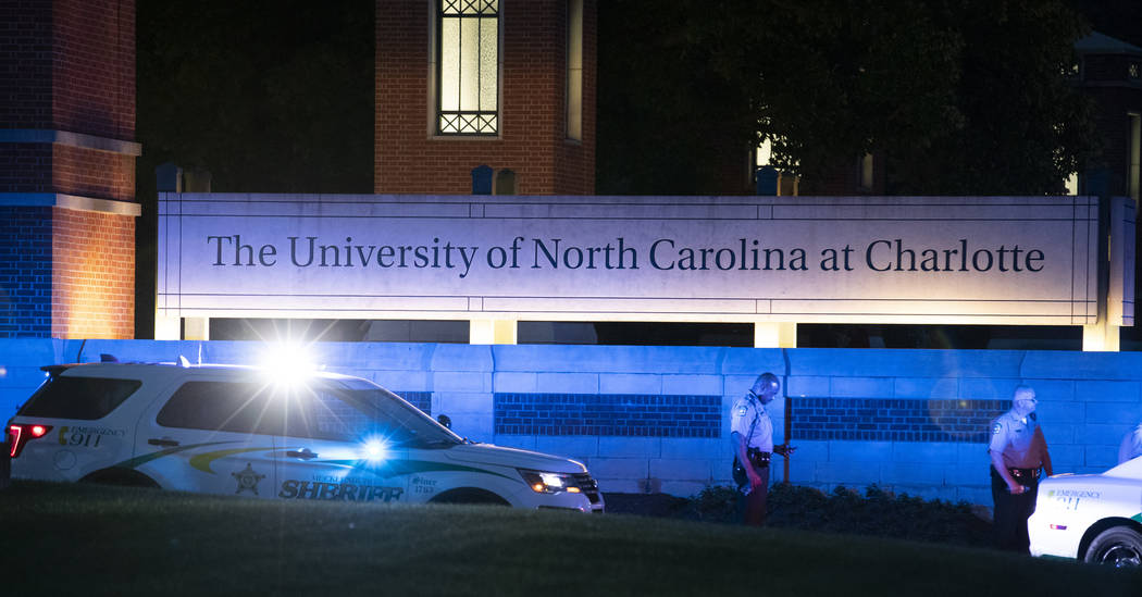 Police secure the main entrance to UNC Charlotte after a shooting at the school that left at le ...