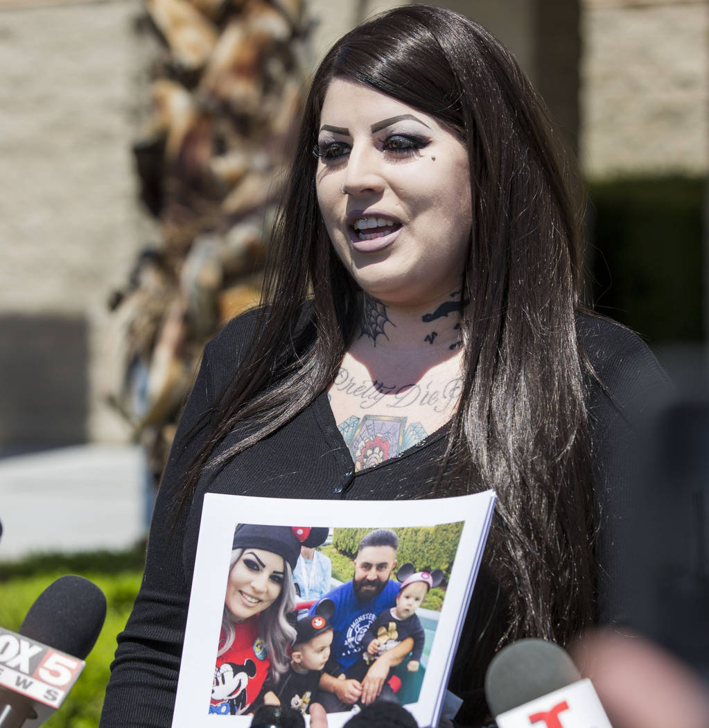 Julie Campos holds a photo of her husband, homicide victim Luis Campos, and their children at t ...