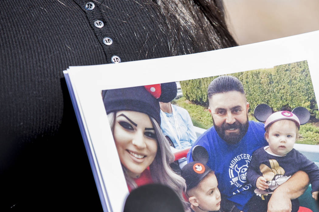 Julie Campos holds a photo of her husband, Luis, and their children at the Metropolitan Police ...