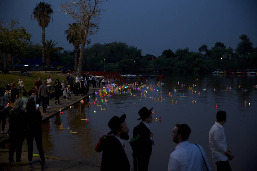 People look on floating handmade boats with the names of Nazi concentration camps, during a cer ...