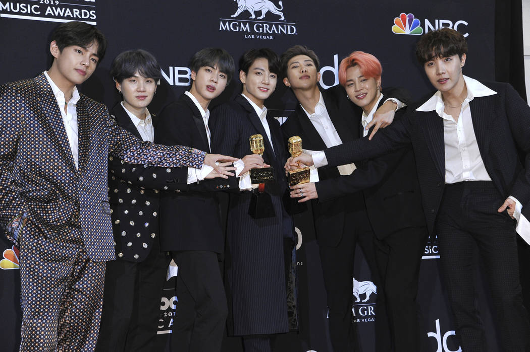 BTS poses in the press room with the award for top duo group and top social artist at the Billb ...