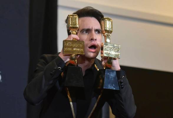 Brendon Urie, of Panic! at the Disco, poses in the press room with the awards for top rock albu ...