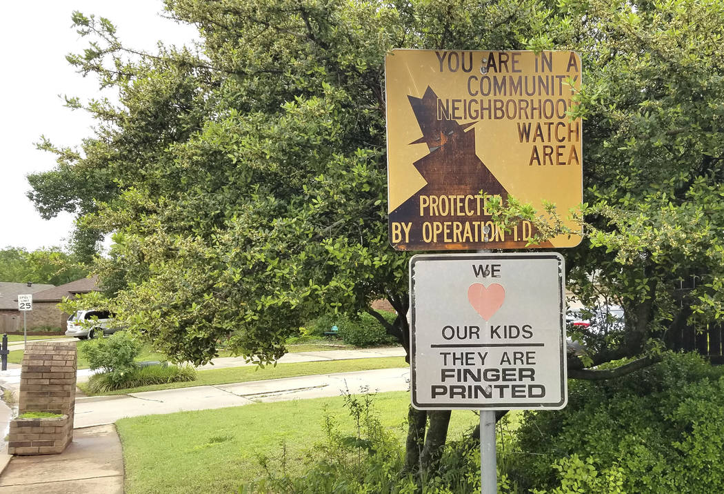 A neighborhood watch sign stands Wednesday, May 1, 2019 at the entry to the Edmond, Oklahoma, n ...