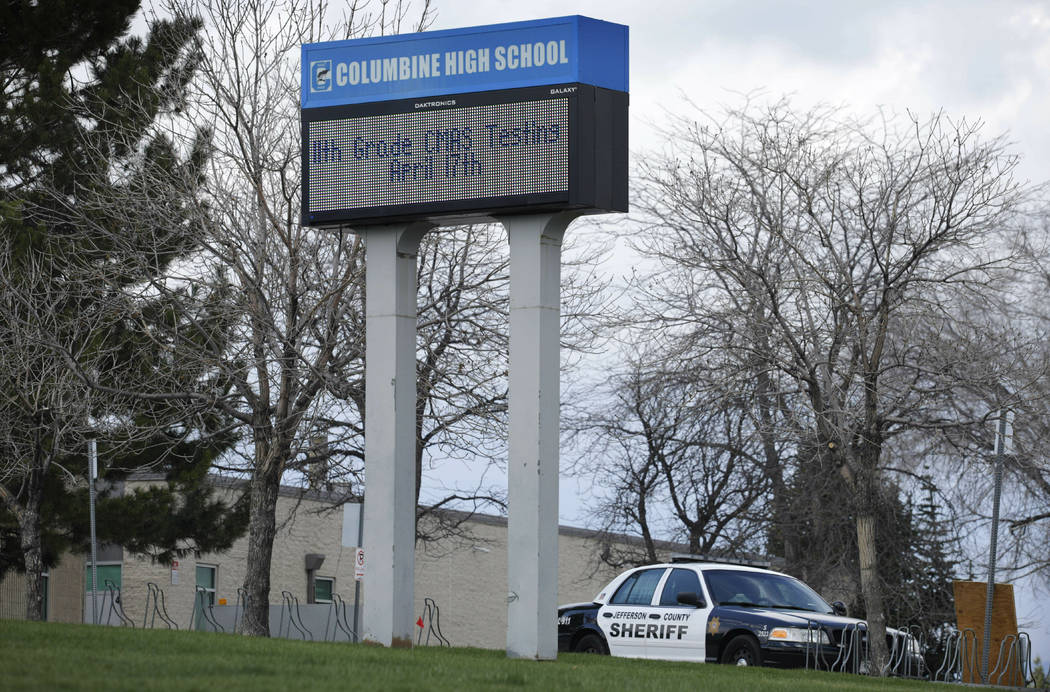 FILE - In this April 17, 2019, file photo, a patrol car is parked in front of Columbine High Sc ...