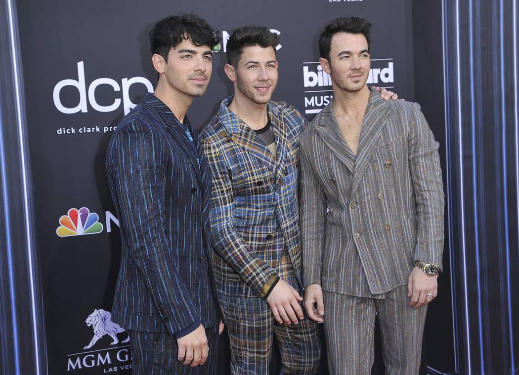 Joe Jonas, from left, Nick Jonas, and Kevin Jonas, of Jonas Brothers, arrive at the Billboard M ...