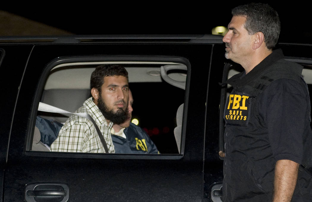 Terrorism suspect Najibullah Zazi is seated in an FBI vehicle after being arrested by the FBI i ...