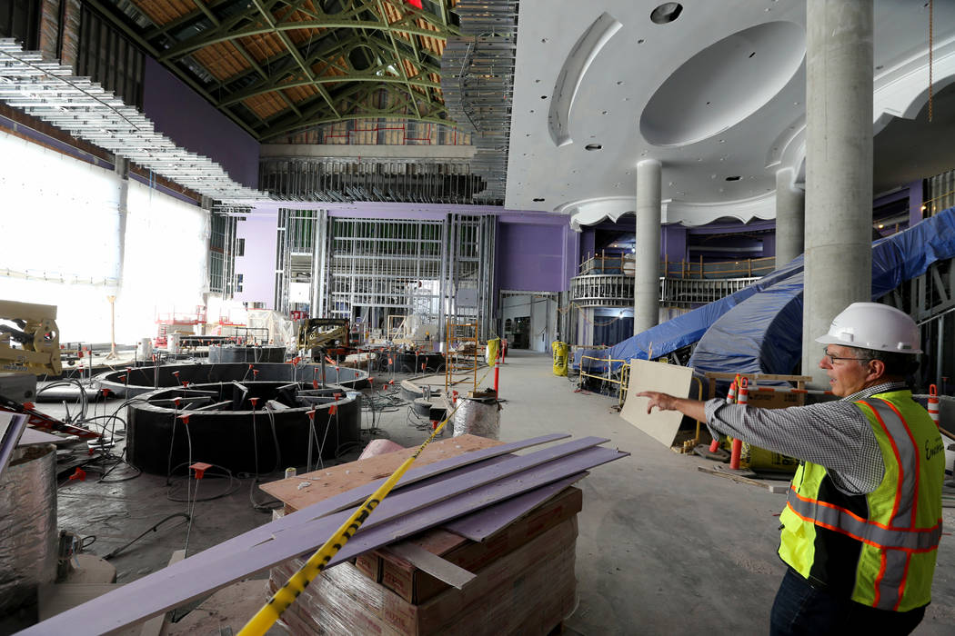 Greg John, executive director of brand marketing, gives a tour of the main lobby of Encore Bost ...