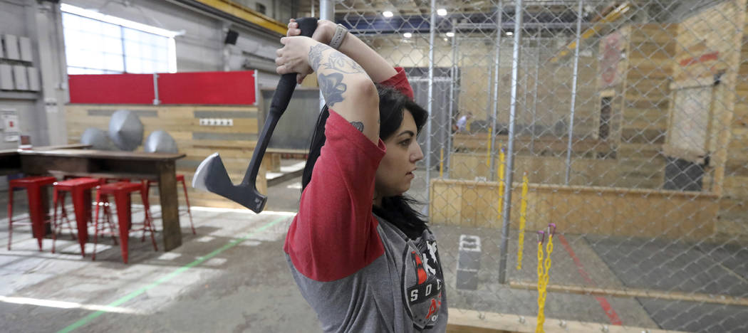 General manager Devan Watanabe throws an axe at Social Axe Throwing Wednesday, May 1, 2019, in ...