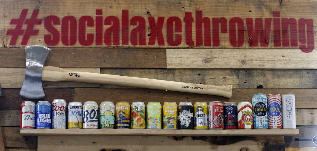 Beers are shown on the wall of Social Axe Throwing Wednesday, May 1, 2019, in Salt Lake City. T ...