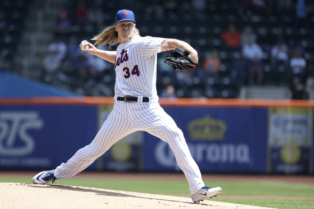 New York Mets starting pitcher Noah Syndergaard throws a pitch to Cincinnati Reds' Derek Dietri ...