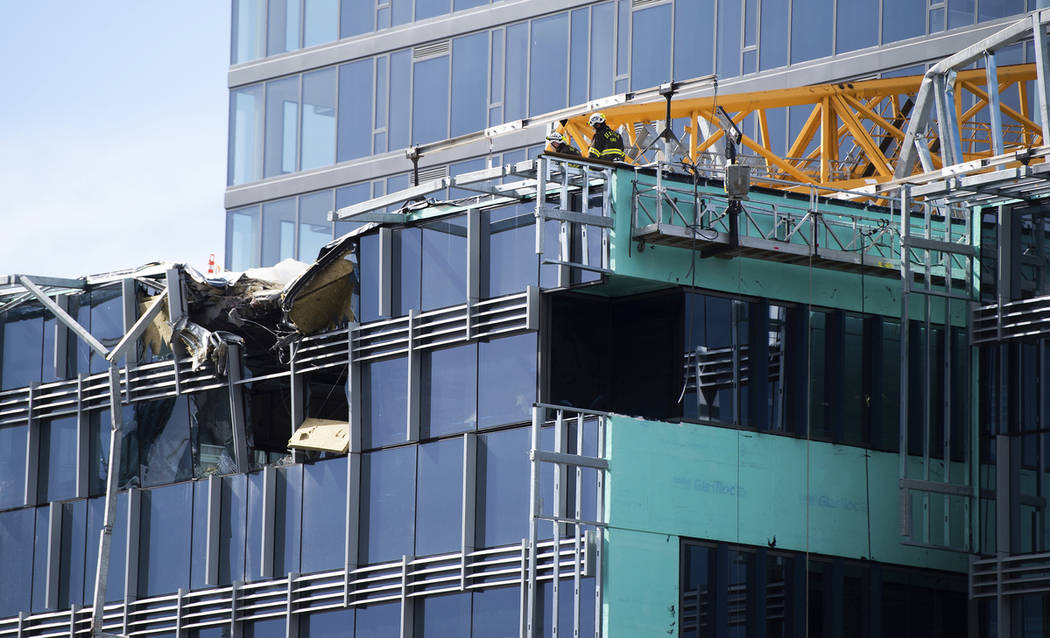 Emergency crews work the scene of a construction crane collapse near the intersection of Mercer ...