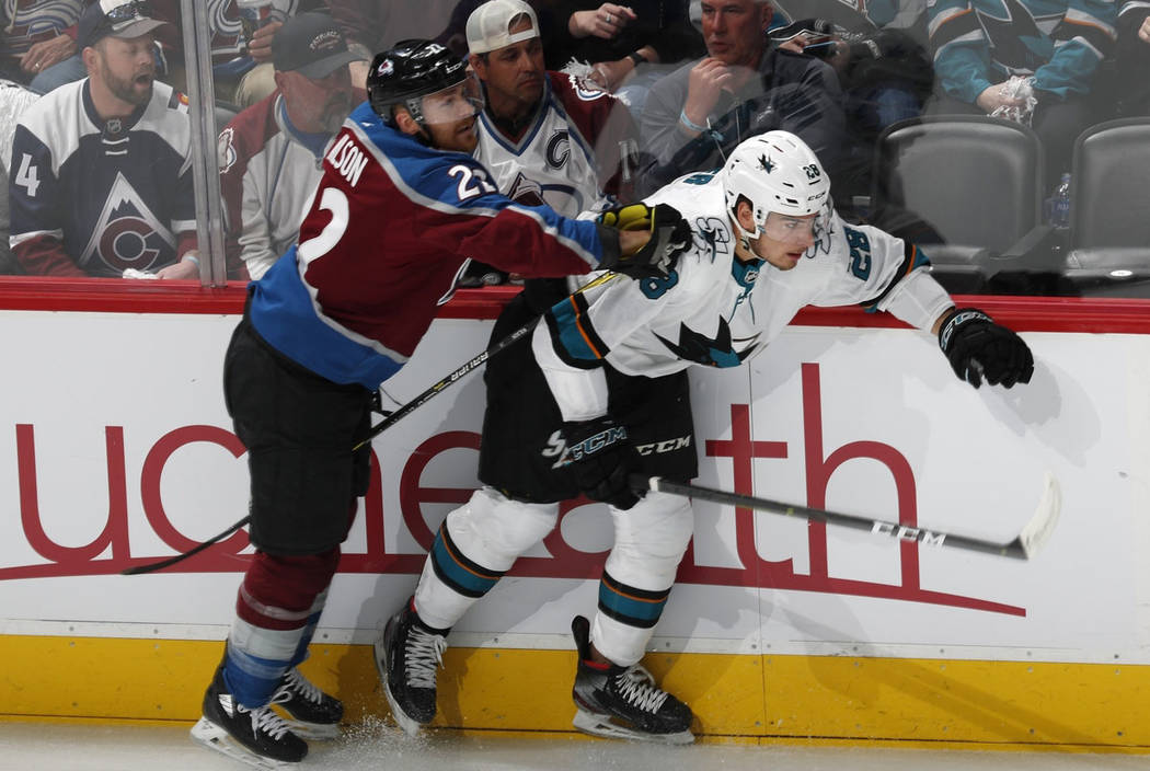 Colorado Avalanche center Colin Wilson, left, checks San Jose Sharks right wing Timo Meier duri ...