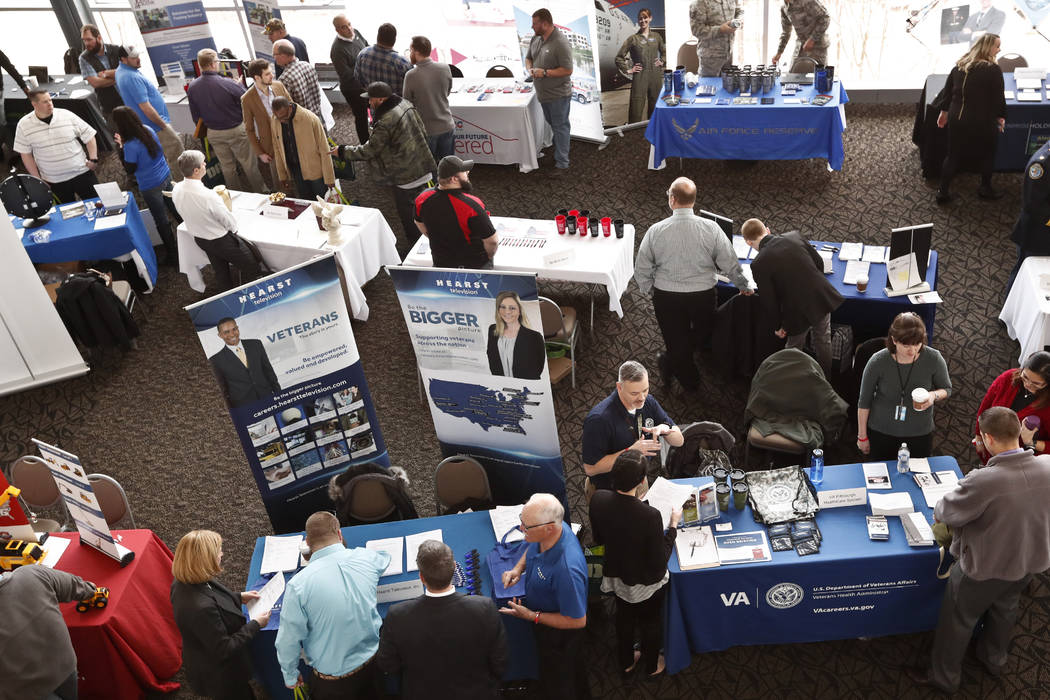 Visitors to a Pittsburgh veterans job fair meet March 7, 2019, with recruiters at Heinz Field i ...