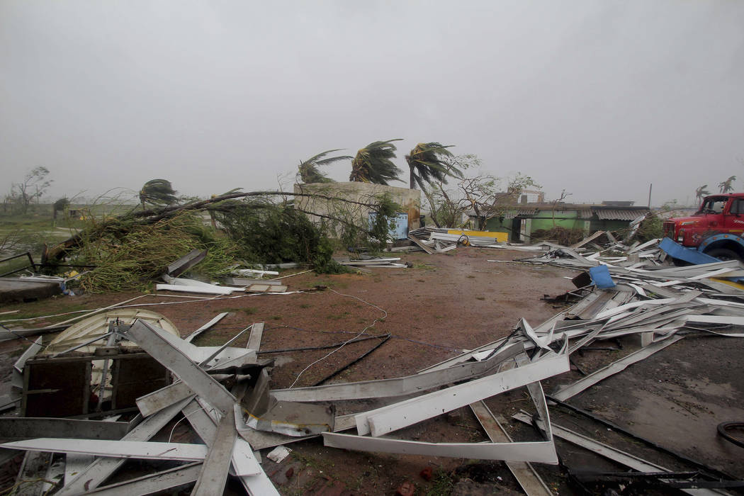 Damaged structures and uprooted tress lie along a road in Puri district after Cyclone Fani hit ...