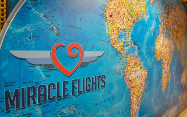 A map with pins showing locations Miracle Flights has traveled to is shown in the organization& ...