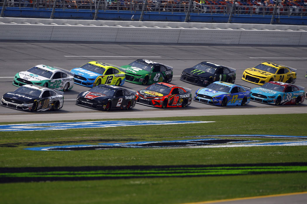 Aric Almirola (10) leads the pack as he wins Stage 1 during a NASCAR Cup Series auto race at Ta ...