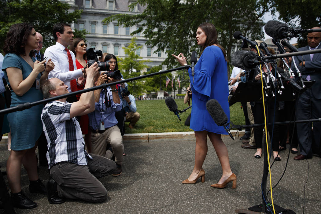 White House press secretary Sarah Sanders speaks with reporters outside the White House, Friday ...