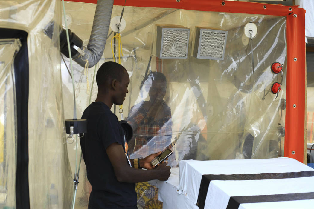 Kasereka Mulanda, 24, talks with his wife who is suffering from the Ebola virus in an isolation ...