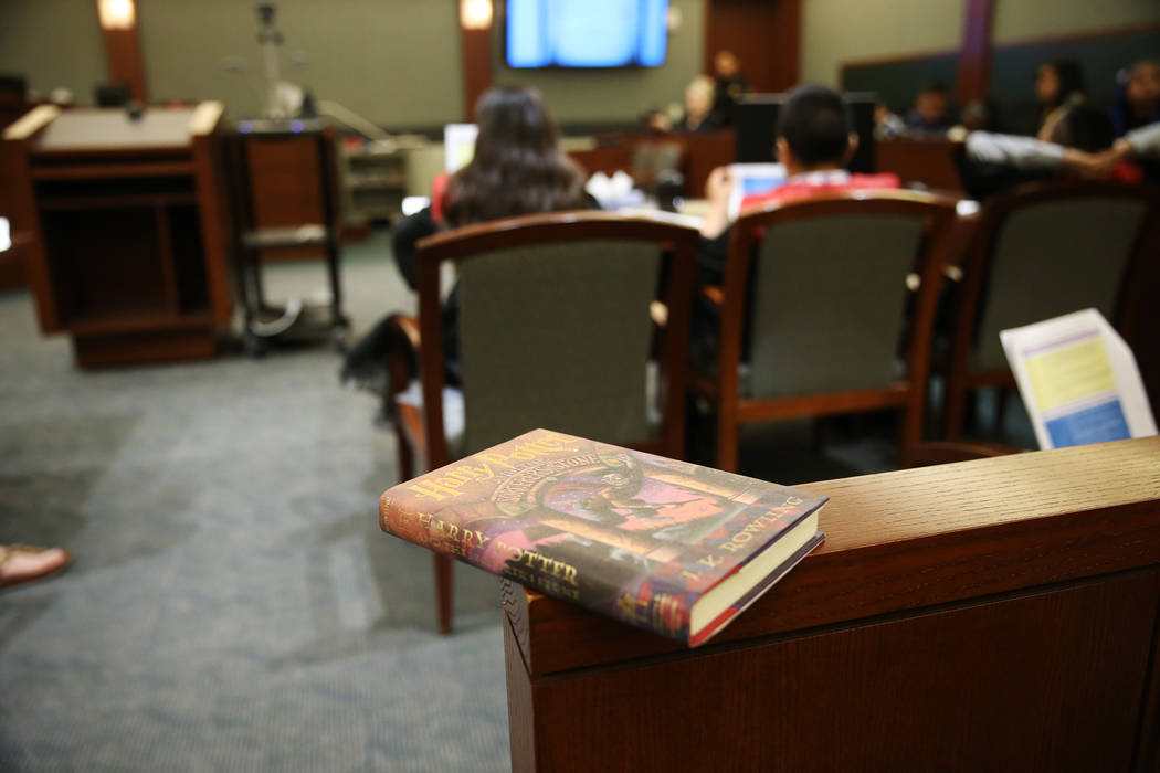 A Harry Potter book sits inside a courtroom during a mock trial with fourth grade students from ...