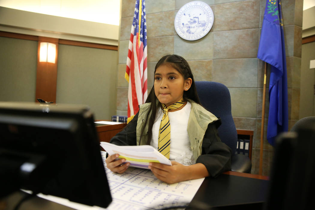 Valeria Rangel, 10, playing a court judge, participate during a mock trial at the Regional Just ...