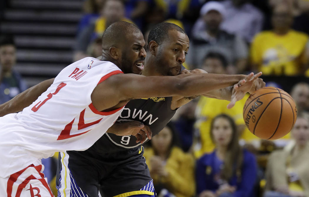 Golden State Warriors' Andre Iguodala, right, defends against Houston Rockets' Chris Paul durin ...