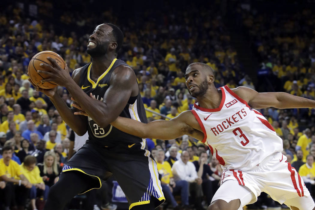 Golden State Warriors' Draymond Green, left, is defended by Houston Rockets' Chris Paul during ...