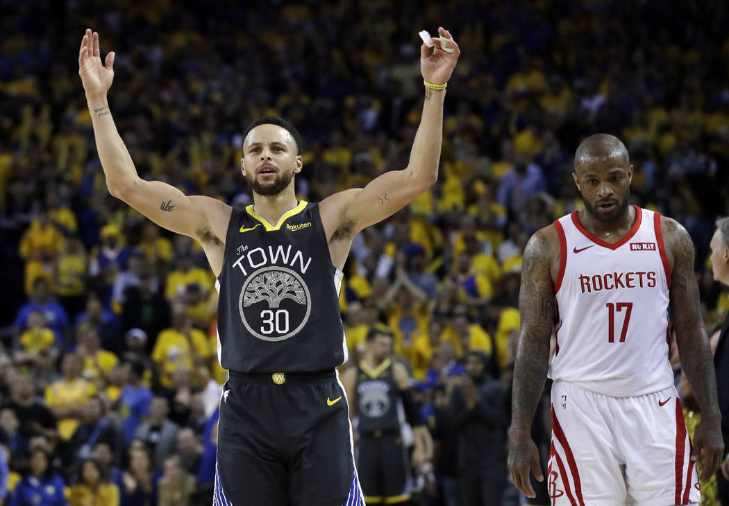 Golden State Warriors' Stephen Curry, left, celebrates next to Houston Rockets' PJ Tucker durin ...