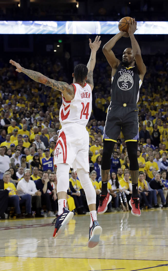 Golden State Warriors' Kevin Durant, right, shoots over Houston Rockets' Gerald Green during th ...