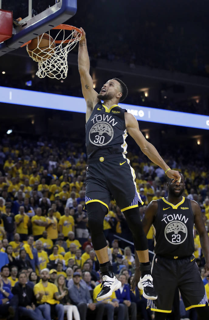 Golden State Warriors' Stephen Curry goes up for a dunk during the second half of Game 2 of a s ...